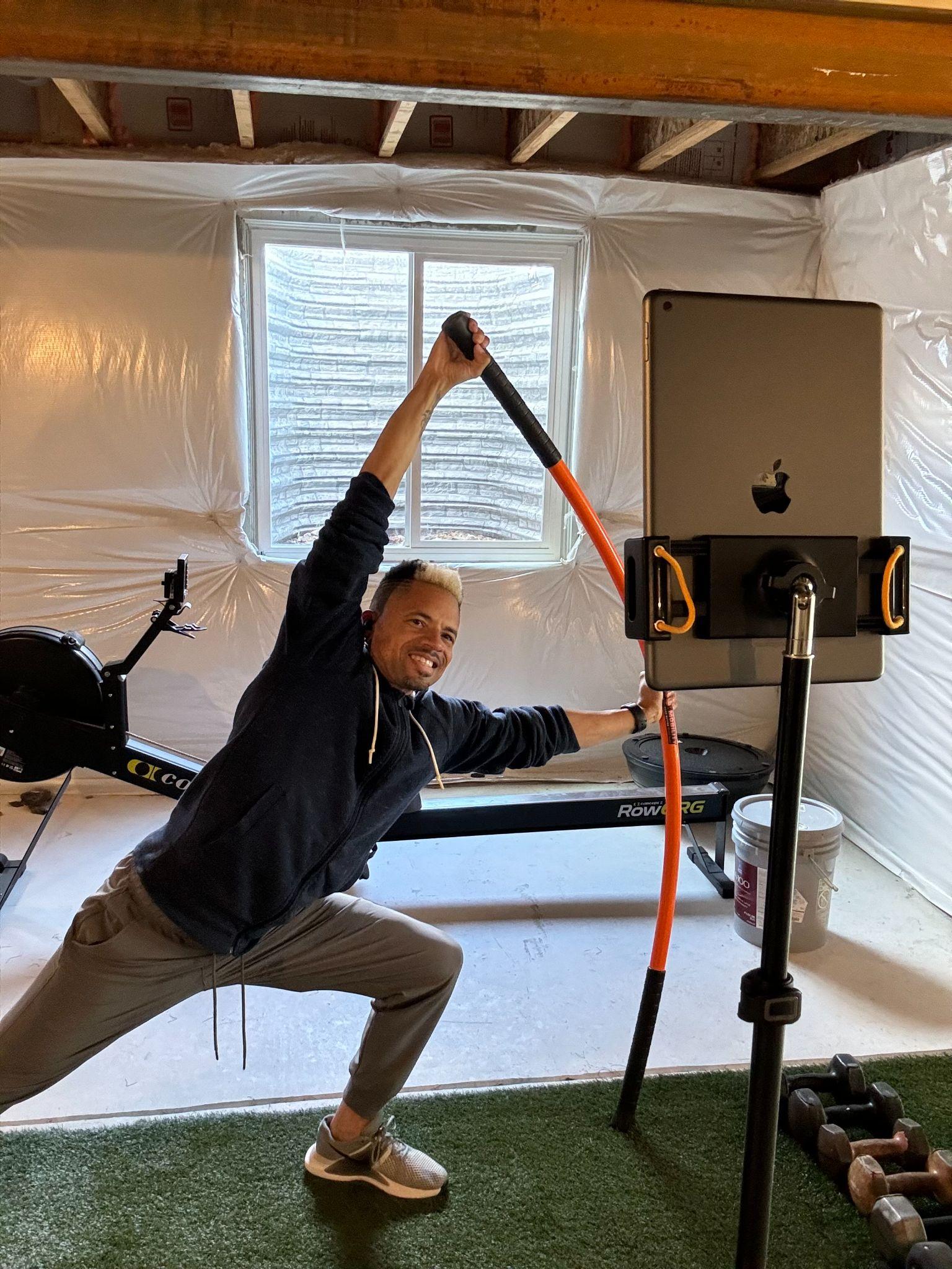 Dr. Darian Parker demonstrating a live virtual personal training session with resistance bands and iPad setup
