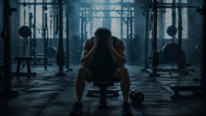 Fitness coach listening attentively to a client after a set — self-talk coaching client mindset session