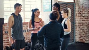 Fitness club floor coach in first session with new member — role-based coaching team standards member retention