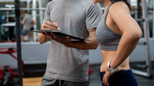 Club operator reviewing member data with a coach — precision wellness longevity member retention 2026