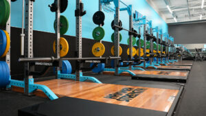 Personal trainer at Club4 Fitness reviewing performance metrics with a manager during a monthly business plan session