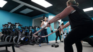 Coach greeting a member by name inside Pure Energie fitness studio in Philadelphia