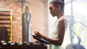 Gym owner reviewing a revenue per member dashboard on a laptop.