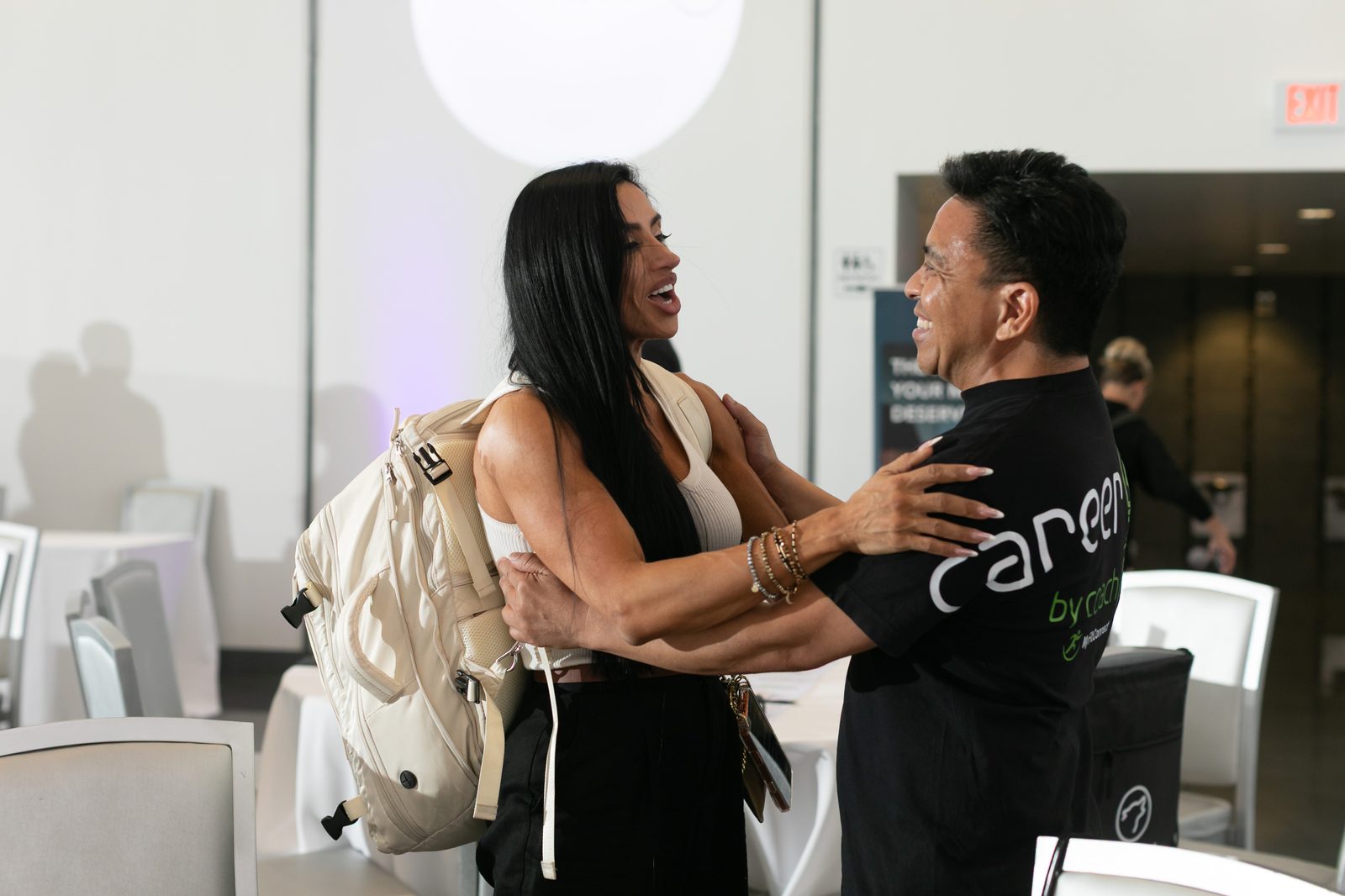 Two coaches greeting each other at Career Lab LIVE