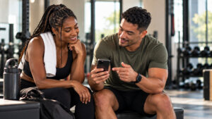 A coach and client reviewing wearable data together, choosing what matters instead of tracking everything.